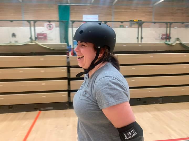 Katy smiling wearing a helmet